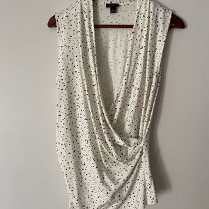 Faux wrap sleeveless shell. Print has a touch of dark green.